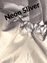 Neon silver fabric with text overlay on a textured background